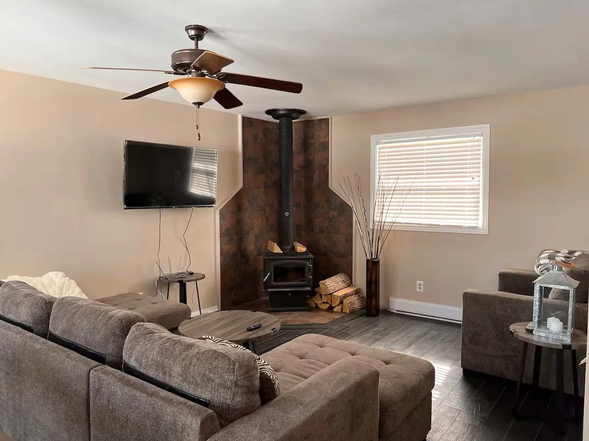 The main cottage living room with its wood stove and seating